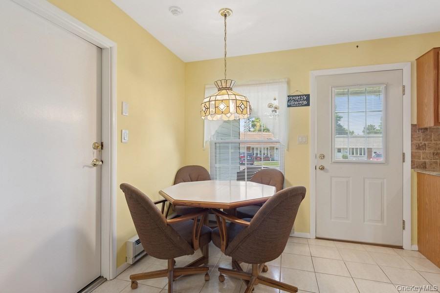 96 Enfield Court, Unit B Ridge, NY 11961 - Photo 7 of 22 a dining room with furniture and window