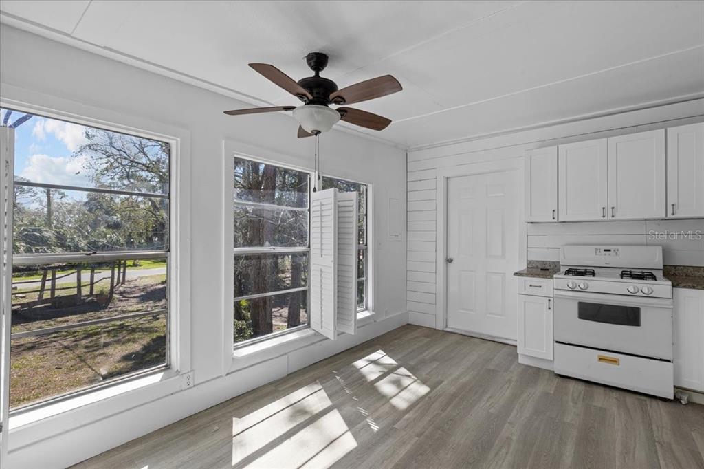 1149 Shell Crest Avenue Cedar Key, FL 32625 - Photo 15 of 32 a view of a kitchen with a sink wooden floor and windows