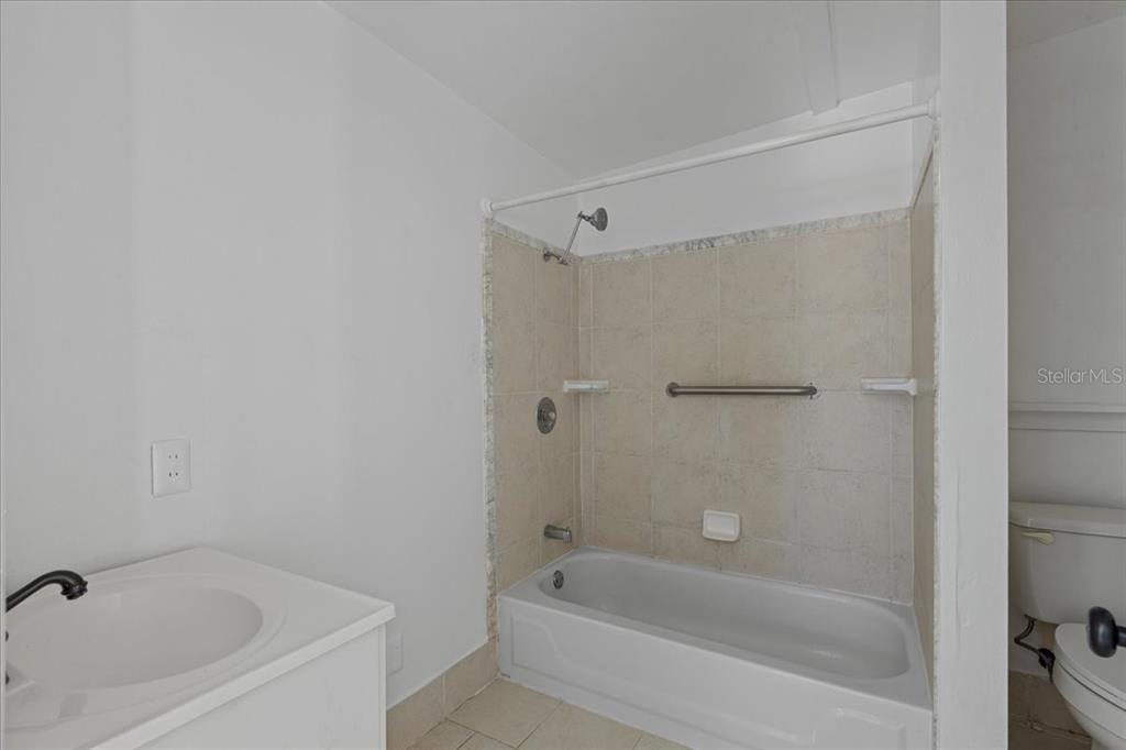 1149 Shell Crest Avenue Cedar Key, FL 32625 - Photo 20 of 32 a white bath tub sitting next to a white sink and vanity