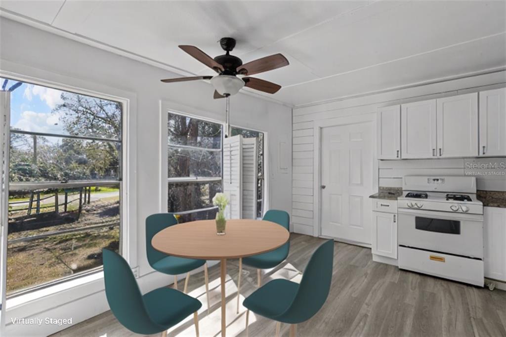 1149 Shell Crest Avenue Cedar Key, FL 32625 - Photo 32 of 32 a kitchen with a dining table chairs and stove