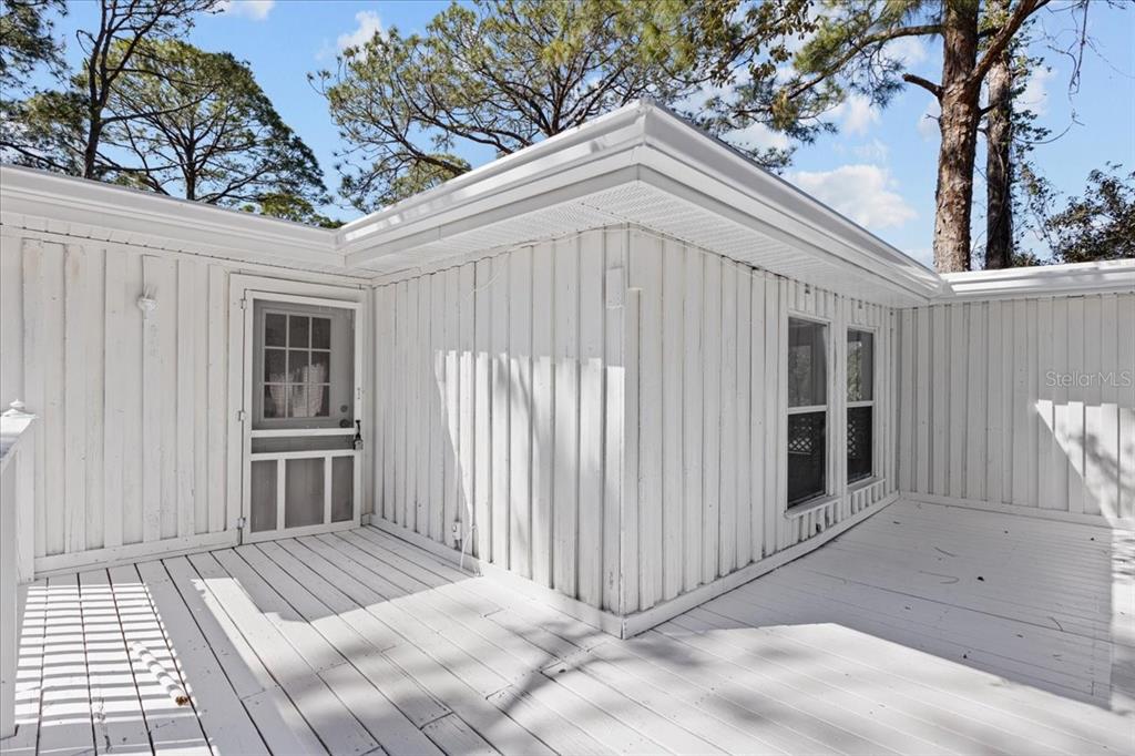 1149 Shell Crest Avenue Cedar Key, FL 32625 - Photo 7 of 32 a view of a house with a door and wooden walls
