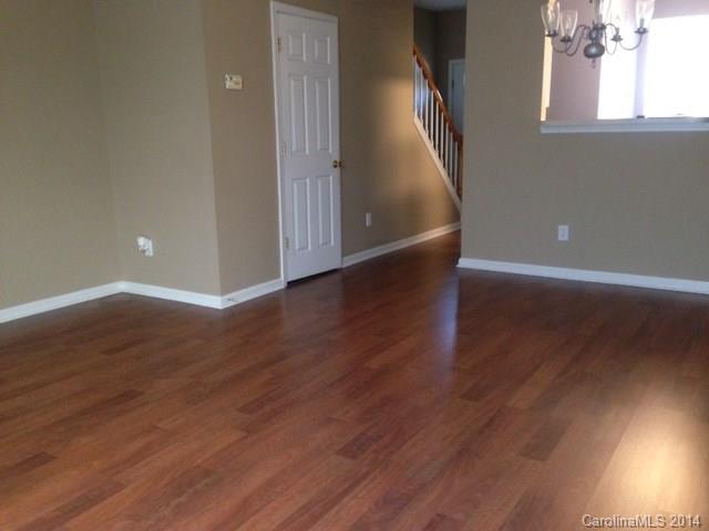 1115 Sienna Sand Way, Unit 111 Fort Mill, SC 29708 - Photo 4 of 15 a view of an empty room with wooden floor and a window