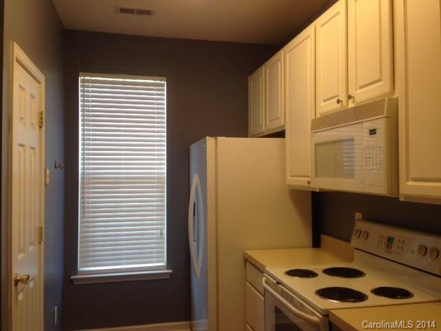 1115 Sienna Sand Way, Unit 111 Fort Mill, SC 29708 - Photo 6 of 15 a bedroom with a stove and a window