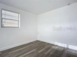a view of a room that has wooden floor in it