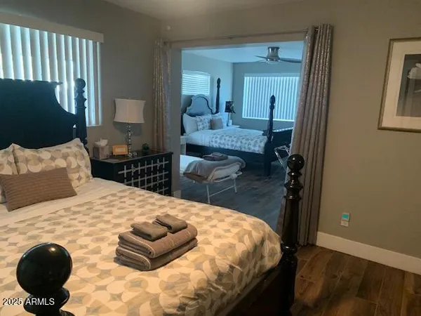 a bedroom with a bed and wooden floor