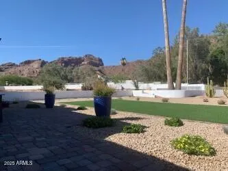a view of a garden with a building in the background