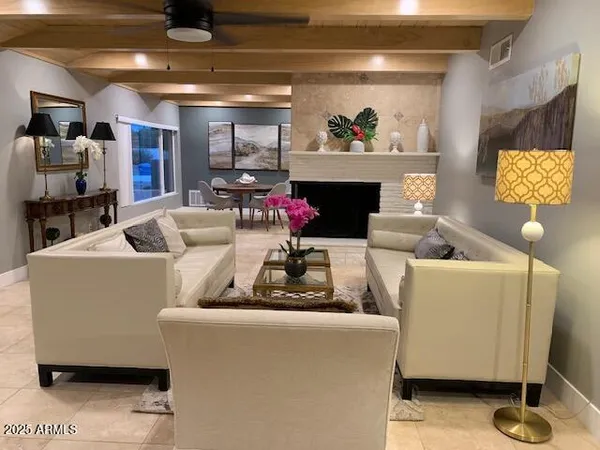 a living room with furniture and a fireplace