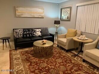 4632 North 49th Place Phoenix, AZ 85018 - Photo 10 of 13 a living room with furniture and a rug