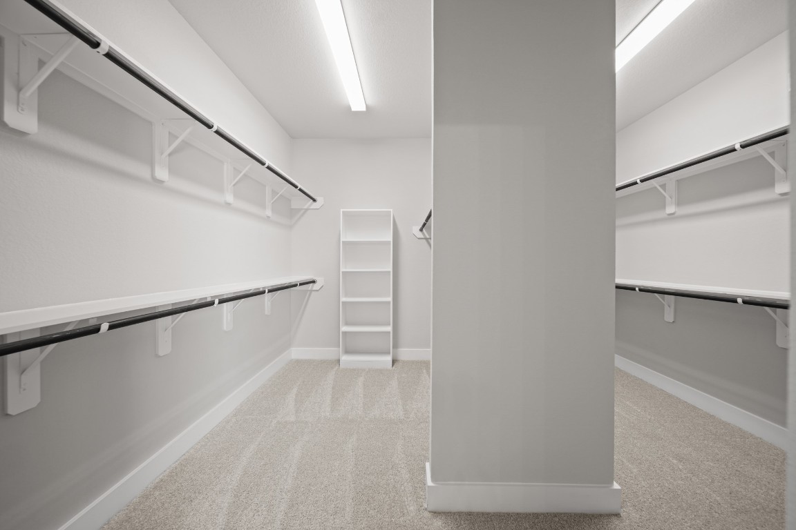 412 Elmbrook Terrace Way Waller, TX 77484 - Photo 19 of 38 a view of walk in closet with empty racks