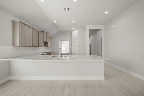 a large white kitchen with a large window