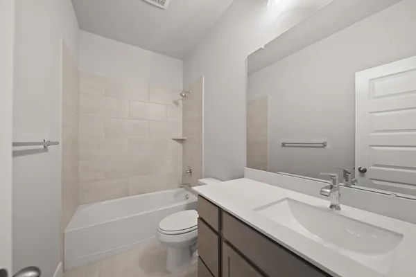 a bathroom with a sink a toilet and bathtub