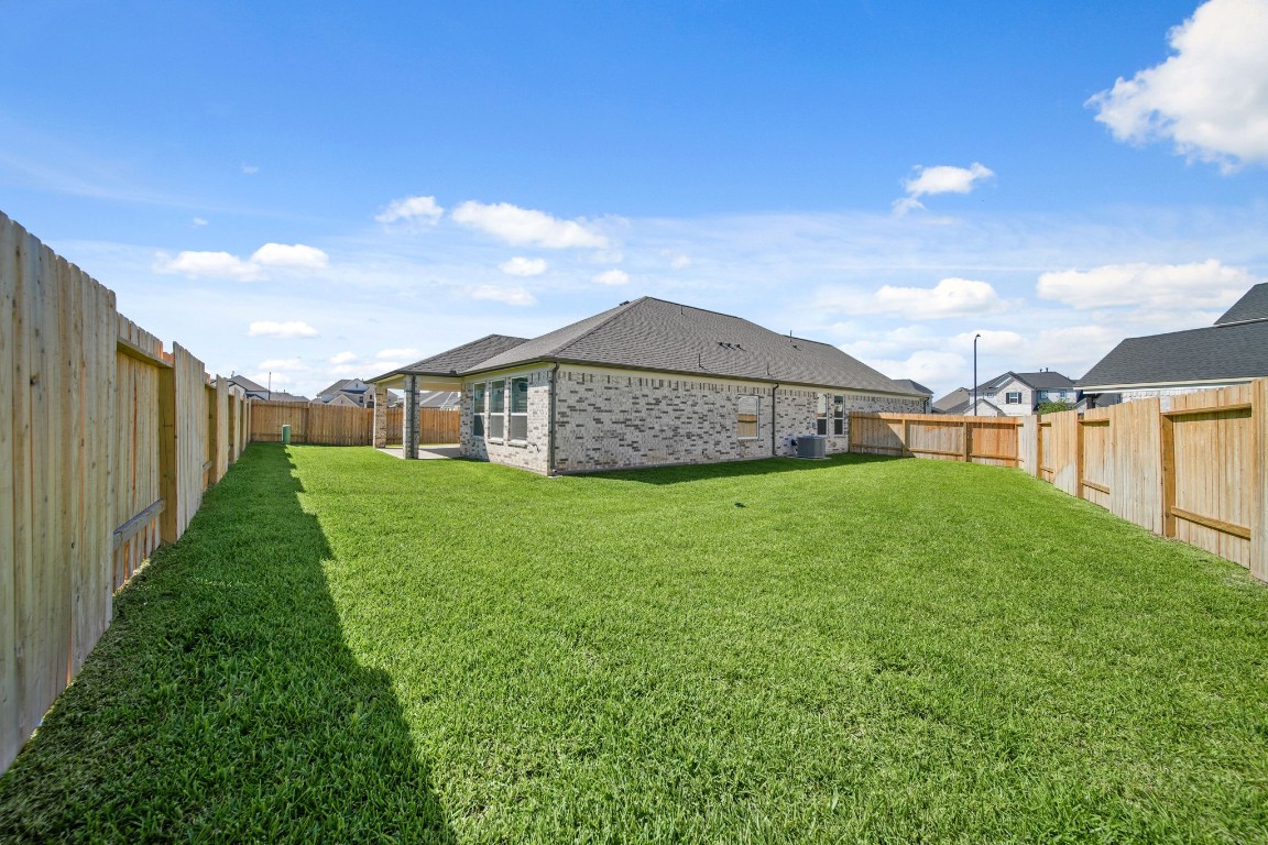 412 Elmbrook Terrace Way Waller, TX 77484 - Photo 26 of 38 a view of a house with a big yard and large tree