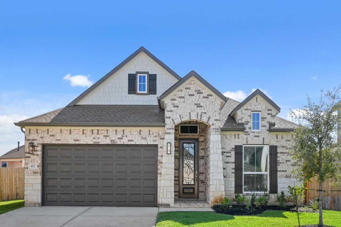 412 Elmbrook Terrace Way Waller, TX 77484 - Photo 27 of 38 a front view of a house with garden