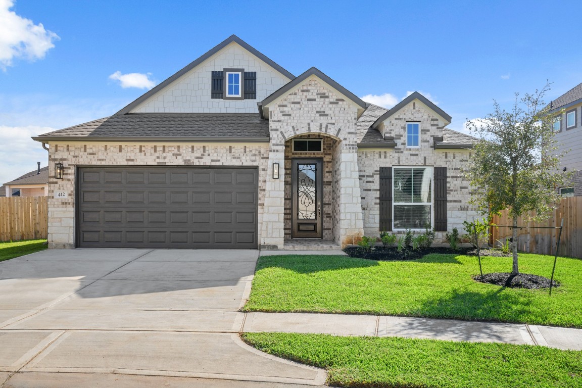 412 Elmbrook Terrace Way Waller, TX 77484 - Photo 28 of 38 a front view of a house with a yard and garage