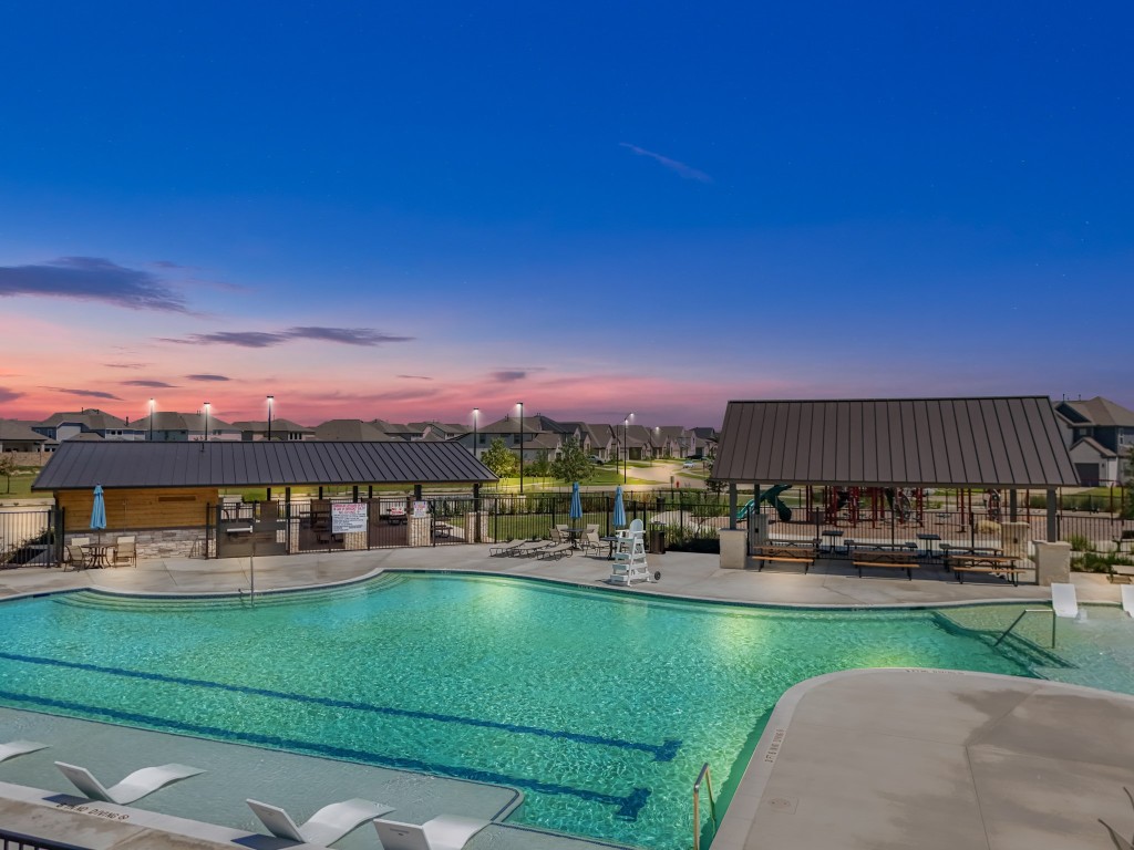 412 Elmbrook Terrace Way Waller, TX 77484 - Photo 33 of 38 a view of a swimming pool with a table and chairs