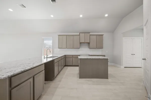 a large white kitchen with a sink