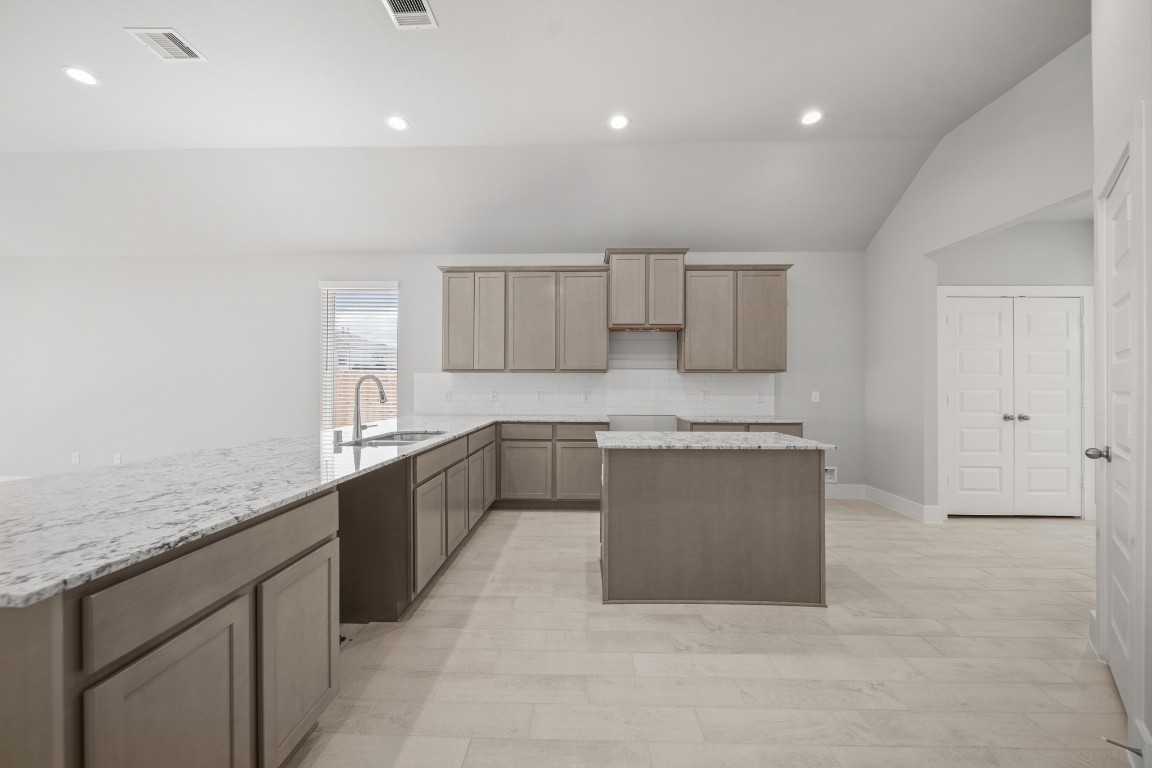412 Elmbrook Terrace Way Waller, TX 77484 - Photo 4 of 38 a large white kitchen with a sink