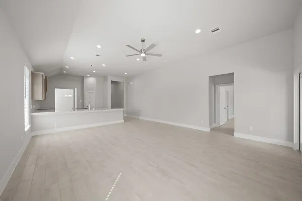 a view of an empty room and a ceiling fan