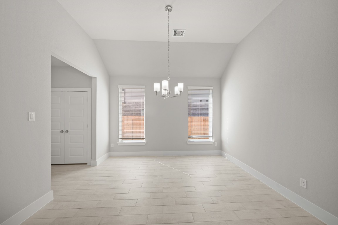 412 Elmbrook Terrace Way Waller, TX 77484 - Photo 10 of 38 a view of an empty room with window and wooden floor