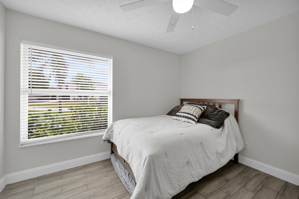 1950 Southwest Logwood Road Port St. Lucie, FL 34953 - Photo 17 of 32 a bedroom with a bed and a window
