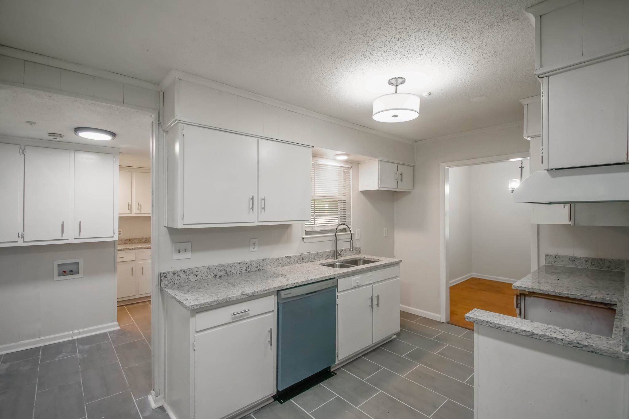 3839 Millbranch Road Memphis, TN 38116 - Photo 8 of 18 a kitchen with stainless steel appliances granite countertop a sink stove and cabinets