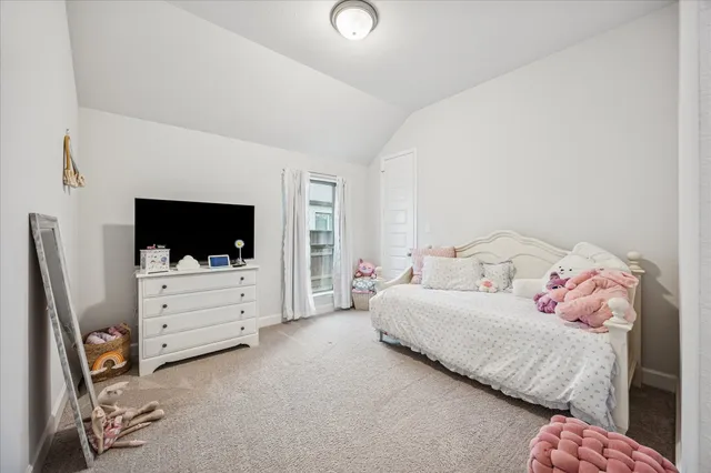 a bedroom with a bed and flat screen tv