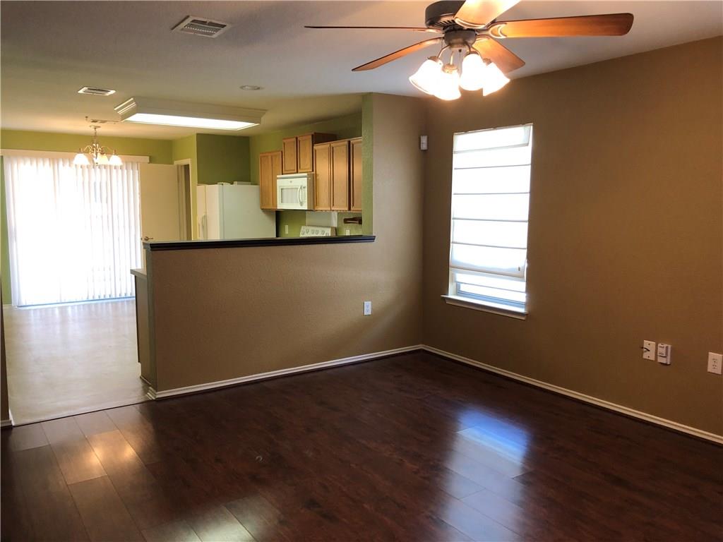 6912 Walkup Lane Austin, TX 78747 - Photo 13 of 14 a view of an empty room with window and wooden floor