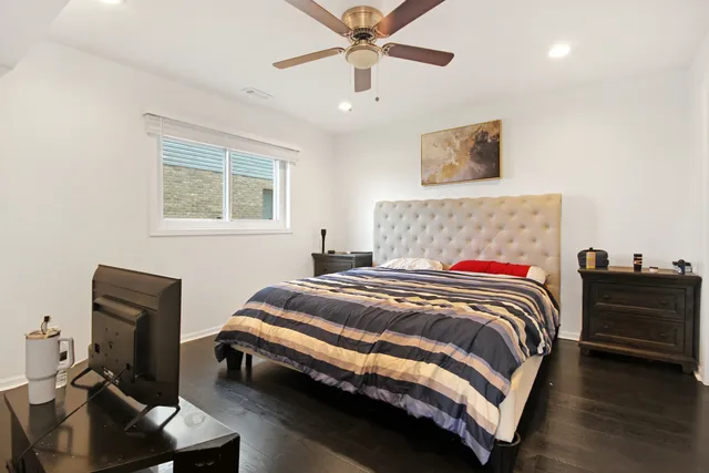 a bedroom with a bed and a desk