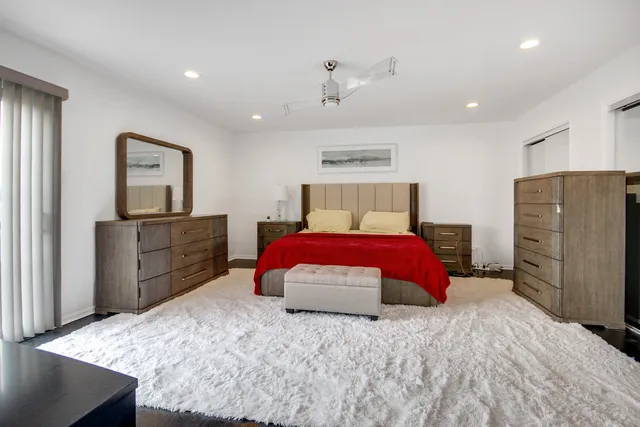 a bedroom with a large bed and a dresser