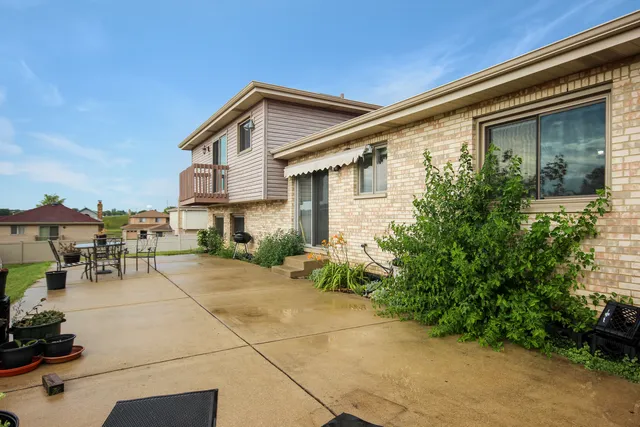 a view of a patio with table and chairs and potted plants