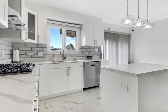 a kitchen with a sink and cabinets