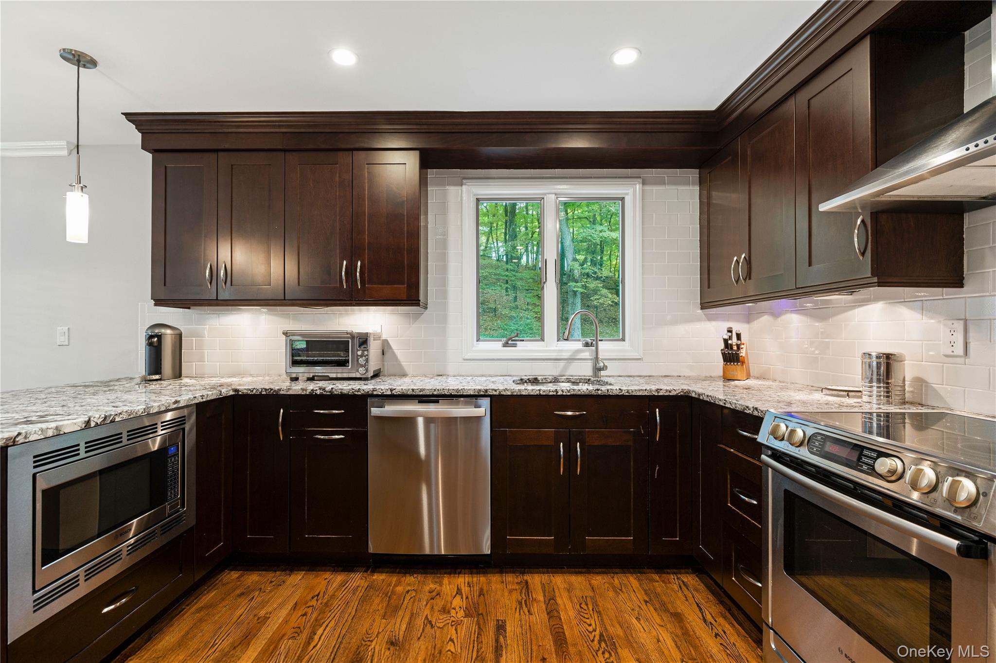 86 Seven Bridges Road Chappaqua, NY 10514 - Photo 11 of 33 a kitchen with granite countertop stainless steel appliances and sink