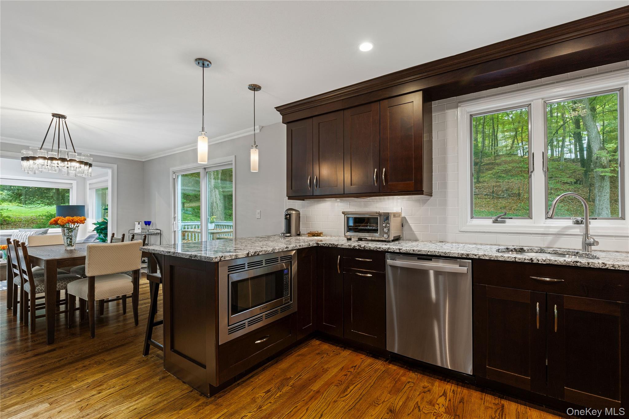 86 Seven Bridges Road Chappaqua, NY 10514 - Photo 12 of 33 a kitchen with lots of counter top space and dining table