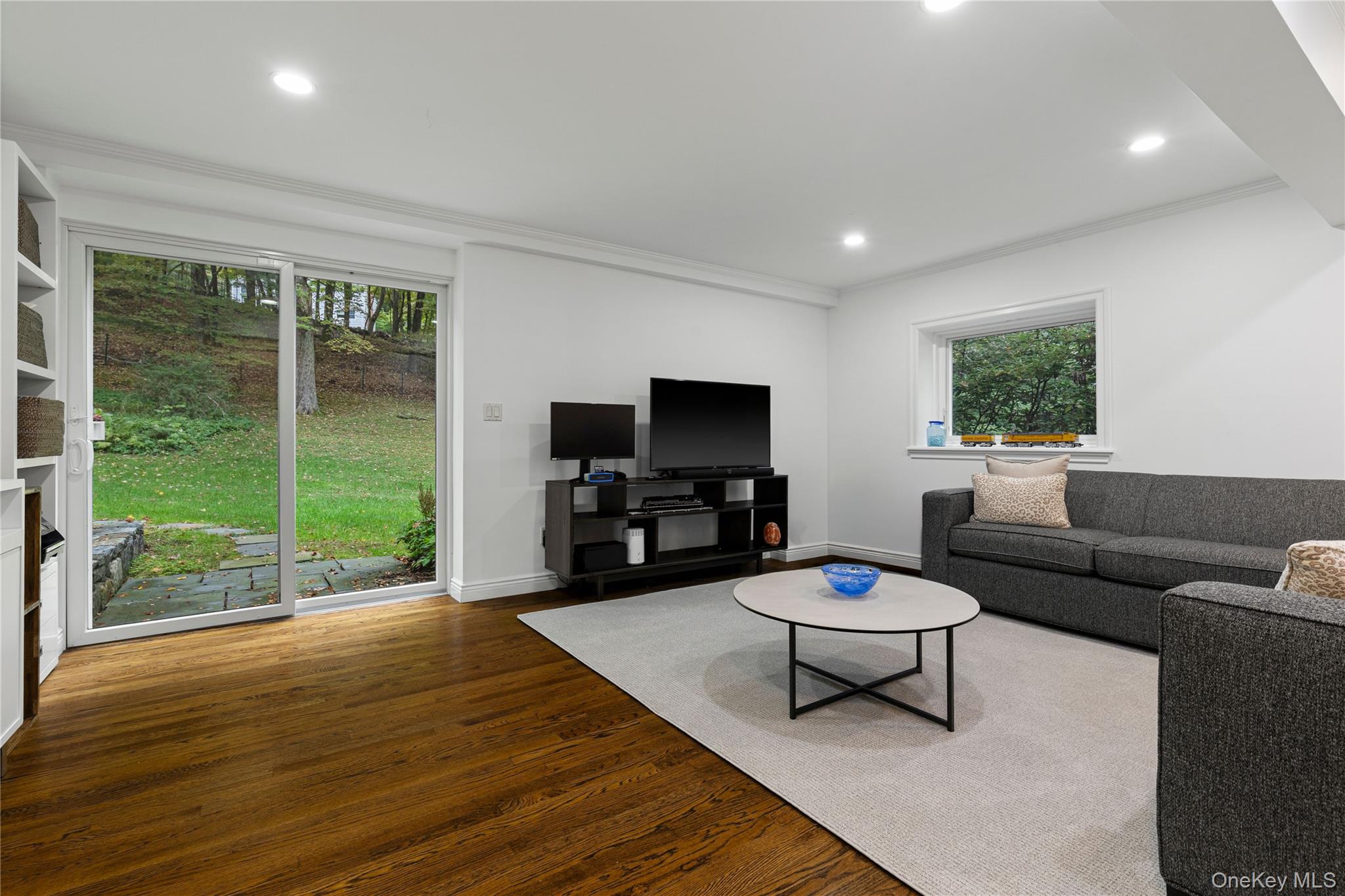 86 Seven Bridges Road Chappaqua, NY 10514 - Photo 13 of 33 a living room with furniture a flat screen tv and a floor to ceiling window