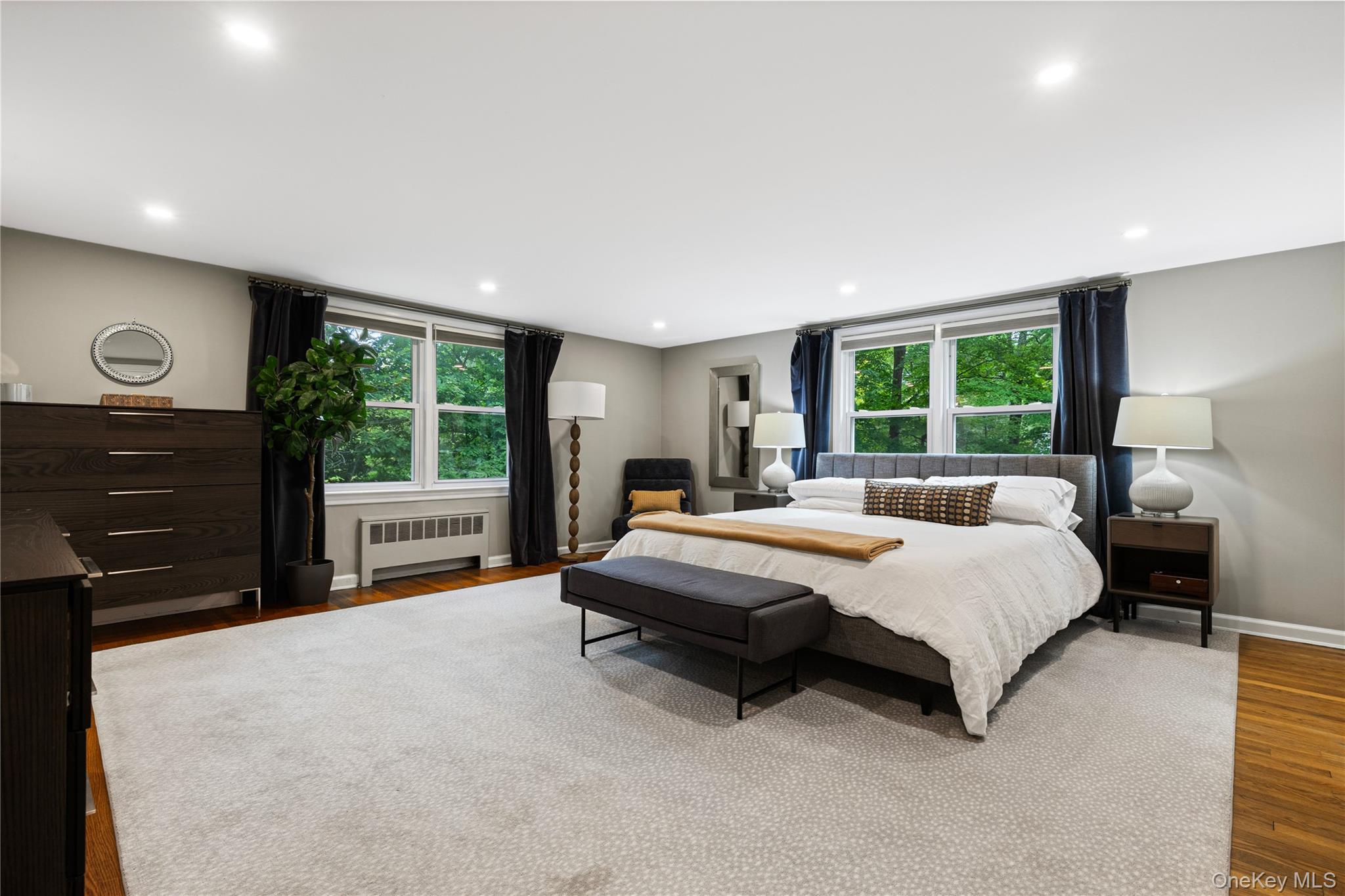 86 Seven Bridges Road Chappaqua, NY 10514 - Photo 15 of 33 a spacious bedroom with a bed and a dresser next to a window