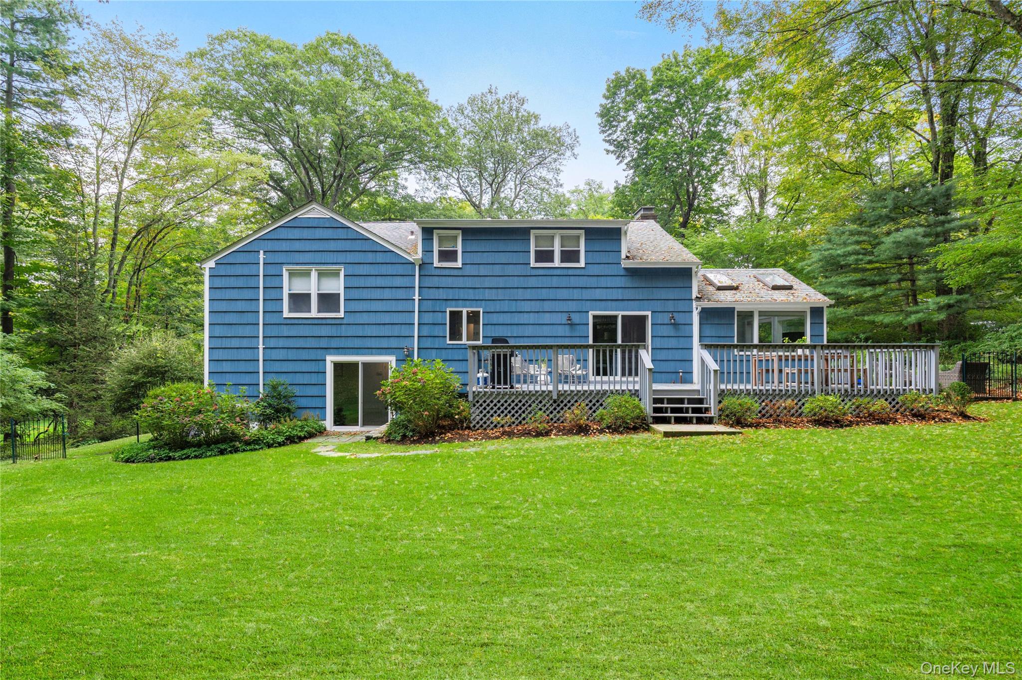86 Seven Bridges Road Chappaqua, NY 10514 - Photo 27 of 33 a front view of a house with a yard and trees