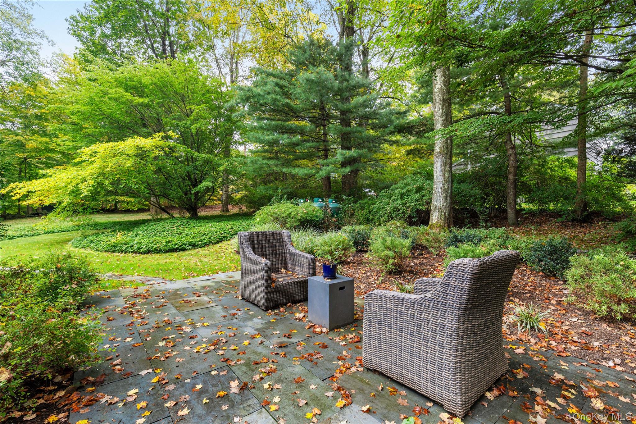 86 Seven Bridges Road Chappaqua, NY 10514 - Photo 28 of 33 a view of a chair and table in the garden