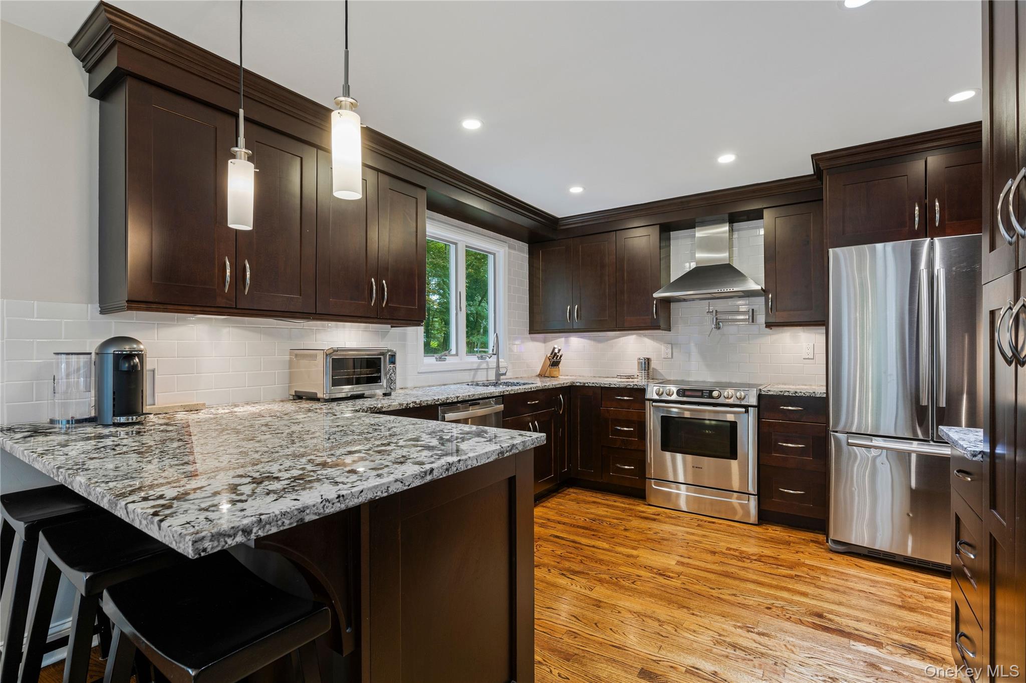 86 Seven Bridges Road Chappaqua, NY 10514 - Photo 10 of 33 a kitchen with granite countertop stainless steel appliances and wooden cabinets