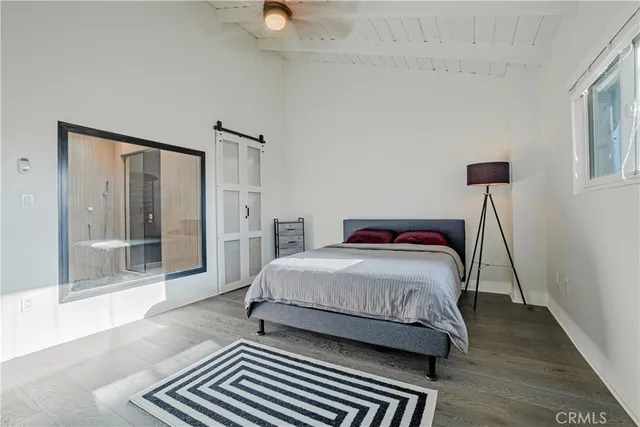 a bedroom with a bed lamp and window