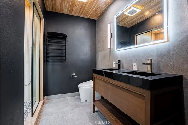 a bathroom with a sink a toilet and a mirror