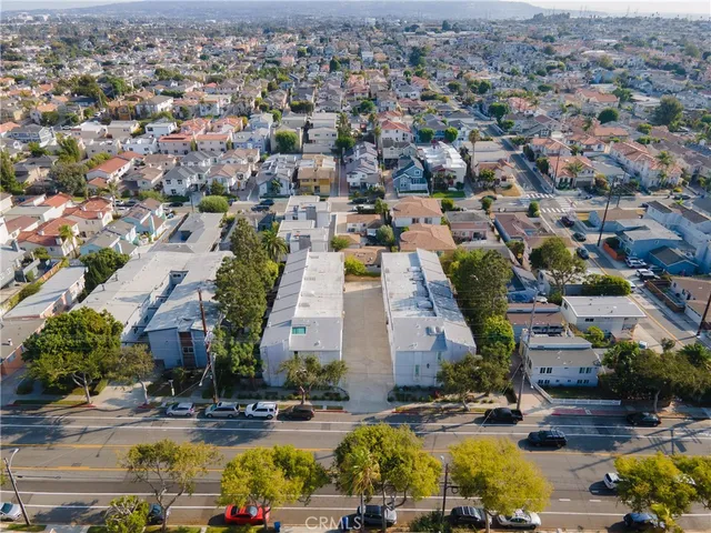an aerial view of residential houses with outdoor space and parking