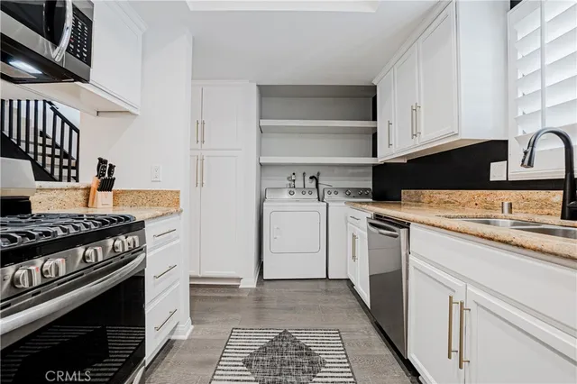 a kitchen with stainless steel appliances granite countertop a stove and a refrigerator