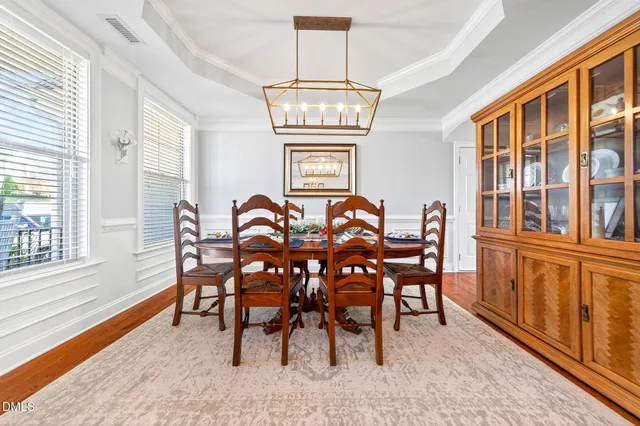 a living room with furniture fireplace and a large window