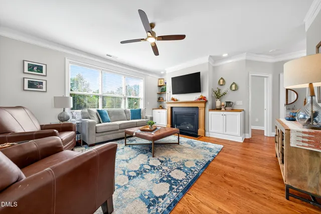 a kitchen with stainless steel appliances kitchen island granite countertop a dining table chairs and a refrigerator