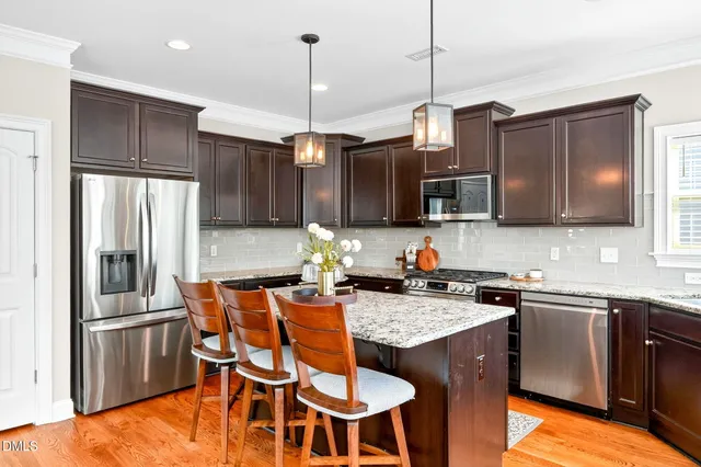 a view of a dining room with furniture wooden floor and a chandelier