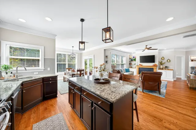 a view of a dining room with furniture wooden floor and chandelier