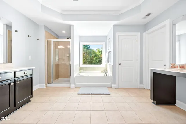 a bedroom with furniture and a flat screen tv