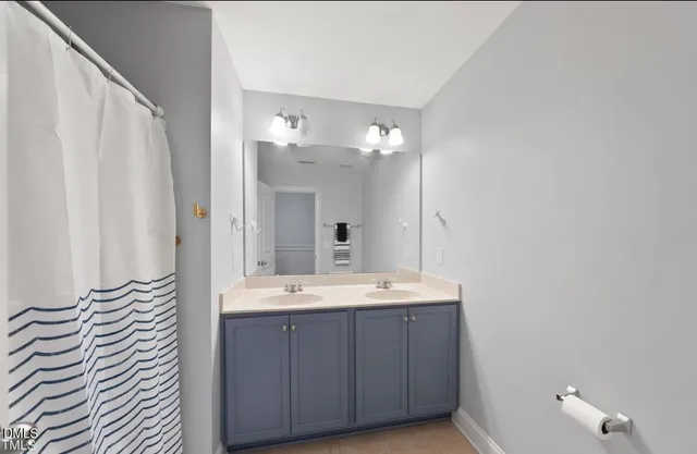 a kitchen with stainless steel appliances a stove a sink a dining table and chairs with wooden floor