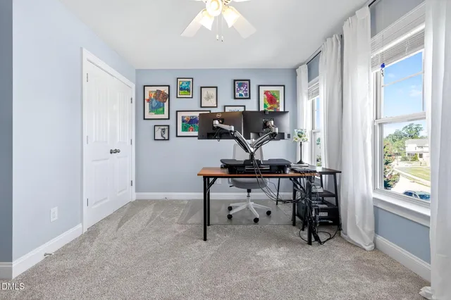 a view of a house with a yard and a garage