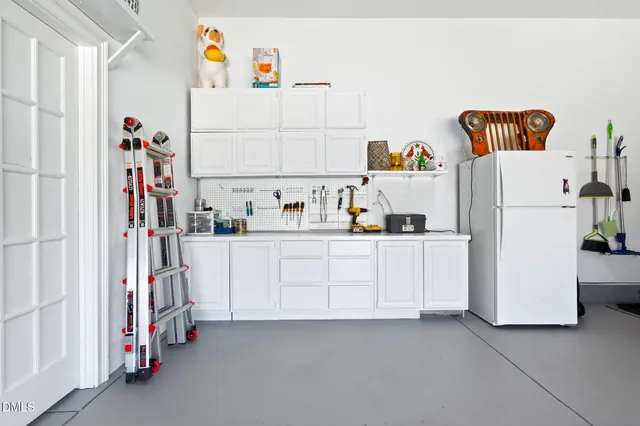an aerial view of a house with swimming pool and large trees